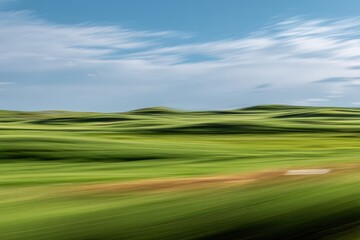 Blurred green hills under a blue sky