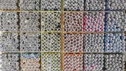 Top view of colorful paper rolls neatly arranged on store shelves in a stationery shop, showcasing vibrant textures and organized display for school, craft, or office supplies