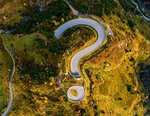 Drone shot of a winding mountain road shaped like a question mark, conceptual journey and decision-making theme.