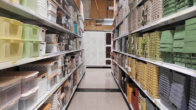 Stationery aisle in a store with neatly arranged stacks of notebooks, paper folders, envelopes, and office supplies, showcasing organization and variety of school and office essentials.