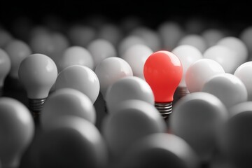 Naklejka premium A single red lightbulb amongst many white ones