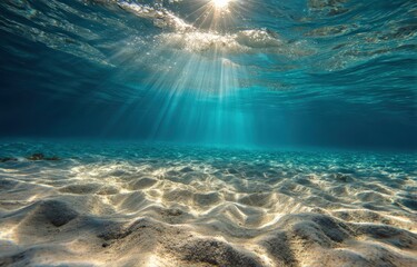 Obraz premium Sunbeams pierce turquoise underwater sand