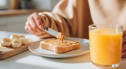 Woman spreading peanut butter on toast