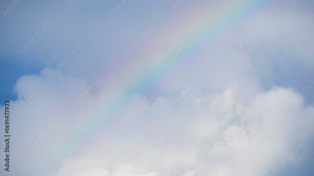 Canvas Prints rainbow in the blue sky with white clouds and copy space.