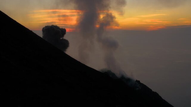 Dramatic eruption of stromboli volcano captured at sunset
