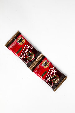 Indonesia, Sukoharjo - June 19, 2025 : black coffee sachets brand steamer (Kapal Api) product from Indonesia, isolated on white background