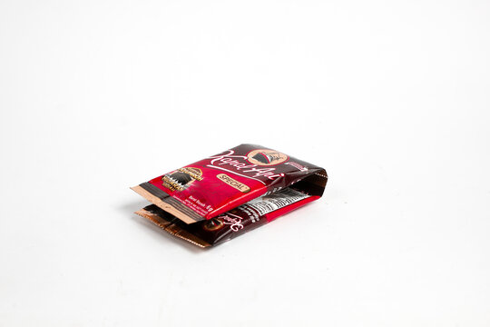 Indonesia, Sukoharjo - June 19, 2025 : black coffee sachets brand steamer (Kapal Api) product from Indonesia, isolated on white background