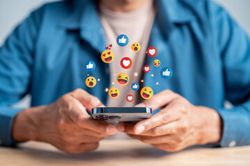 Digital content and engagement concept. Man using smartphone with social media interaction, online feedback, and emotional expression in mobile communication.