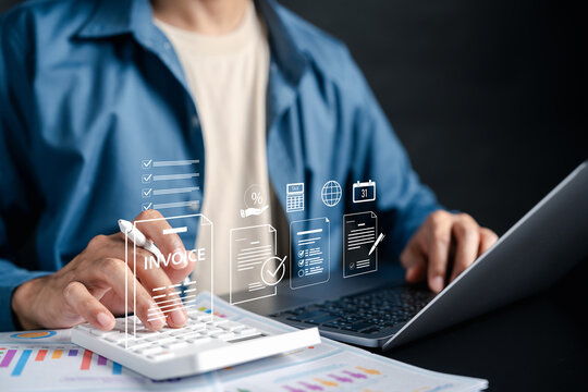 Invoice bill and digital accounting concept. Businessman using calculator and laptop with invoice online billing system, tax calculation, and financial documentation.
