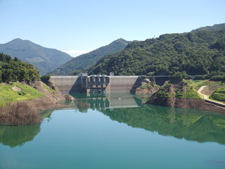 Gunma, Japan - September 7, 2025: Appeared due to drought, submerged disused railroad tracks, roads, basements and trees under the water of Yamba Dam in Gunma, Japan