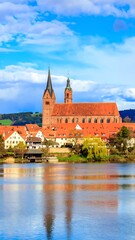 Fototapeta premium Picturesque town by a lake with a church