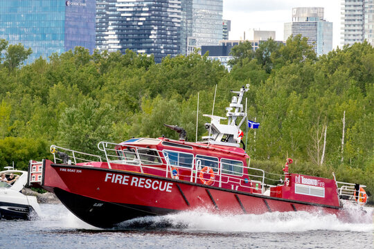 Toronto Canada, August 30, 2024; Toronto Marine Fire Rescue Fireboat 334 with twin diesel jet propulsion with Centre Island and bank towers in the background
