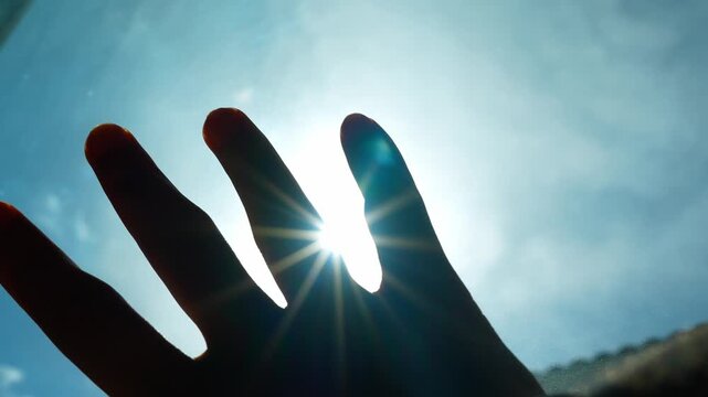 Reaching up to block the glaring sun reflects setting boundaries, managing exposure, and adapting to the environment. It highlights awareness, self-protection, and navigating obstacles.
