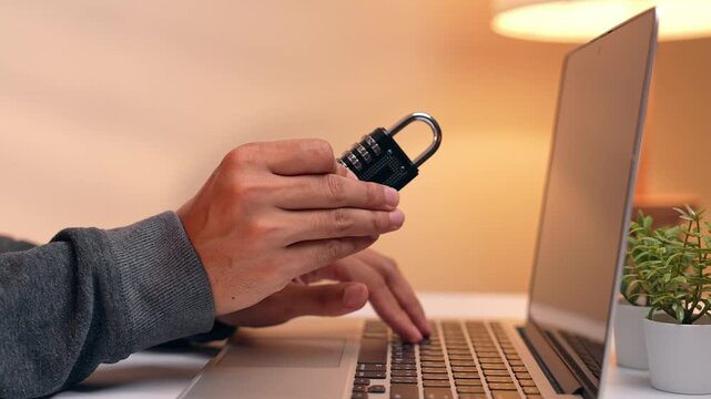 The hacker&rsquo;s focus on the padlock conveys attempts to decipher digital protections. This scene embodies ideas of data privacy, hacking methods, online safety, encryption, and cybersecurity awareness.
