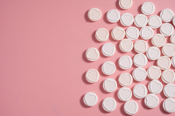 Heart-shaped candies over pink background, abstract food love background, copy space