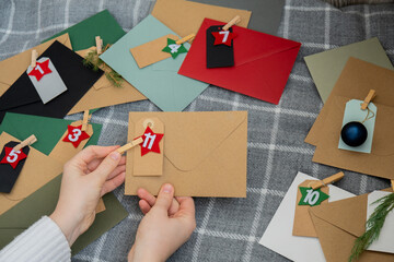 Traditional twenty four days advent calendar before Christmas holidays. Numbers on envelopes Plastic free zero waste sustainable decoration. Winter cozy home Catholic traditions of Christmas countdown
