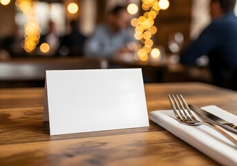 A formal dining table is set with silverware, plates, and a blank place card ready for a guest's name.