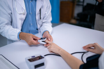 Doctor measuring patient's oxygen saturation with pulse oximeter in hospital room
