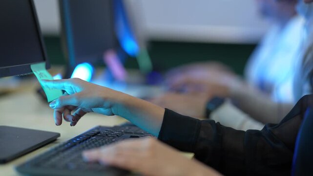 A software developer's hands type rapidly on a keyboard, writing source code in an IDE. This illustrates the fast-paced nature of data input in a tech environment.