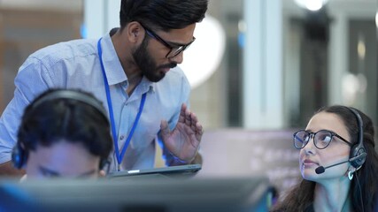 A contact center manager provides on-the-job coaching to a new CSR, explaining a complex customer ticket and reviewing the call script to improve her performance metrics. - Powered by Adobe