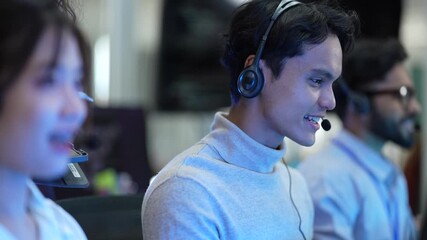 A diverse team of customer support agents works in a modern call center. Smiling operators assist clients over the phone, providing helpful and professional technical support. - Powered by Adobe