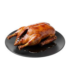 Roasted duck on black plate with glaze drippings isolated on white background
