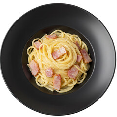 Carbonara pasta with crispy pancetta in a deep black bowl top view isolated on white background