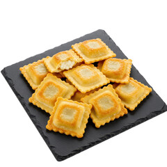 Golden brown ravioli with creamy filling on slate isolated on white background