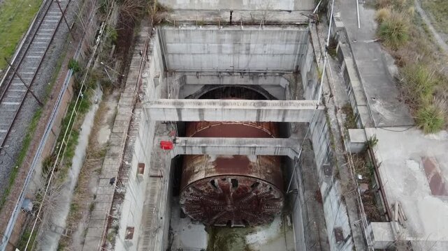 Dynamic aerial shots showing the lack of activity in the Sarmiento Railway tunnel boring machine pit in Villa Luro, Buenos Aires. The work is halted.