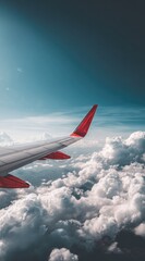 Airplane wing, red-tipped, soars above fluffy white clouds against a gradient blue sky.  The atmosphere is calming, emphasizing freedom and travel adventure