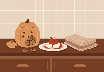 Delightful autumnal kitchen counter featuring a charming pumpkin cookie jar, fresh apples, and soft towels, perfect for a halloween themed gathering