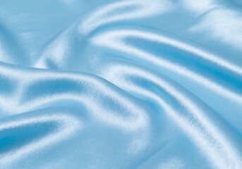 Naklejka premium Close-Up of Blue pastel Satin Fabric with Shiny Elegant Texture and Smooth Waves for Luxury and Premium Background Design
