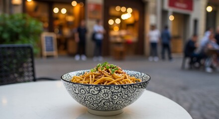 Appetizing Asian Noodles in Patterned Bowl, Street Cafe Setting, Bokeh Lights