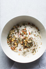 overhead view of savory biscotti ingredients in a bowl, top view of savory cookie ingredients in a mixing bowl