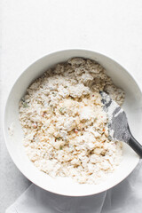 overhead view of savory biscotti dough in a bowl, top view of savory cookie dough in a mixing bowl
