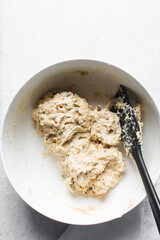 overhead view of savory biscotti dough in a bowl, top view of savory cookie dough in a mixing bowl