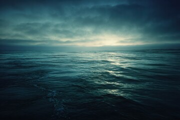 Tranquil Ocean Waters Under Dramatic Cloudy Sky at Dusk