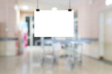 Blank poster mockup hanging with clips in hospital corridor, empty advertising board template background