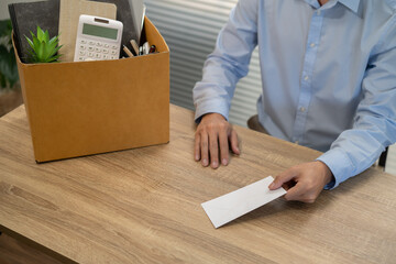 sending resignation letter to boss and Holding Stuff Resign Depress or carrying cardboard box by desk in office