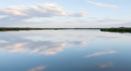 Calm water reflecting clouds