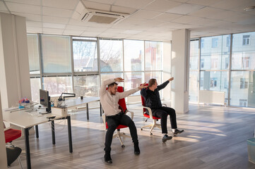 Two Caucasian men having fun at work. 