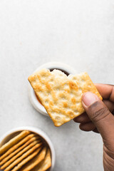 Overhead view of homemade crackers on white marble countertop, top view of cracker biscuits on white background