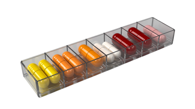 Assorted colorful capsules in a clear pill organizer for medication schedule