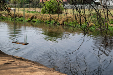 Swing seen hanging over river