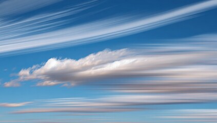 Moving clouds across a vibrant blue sky