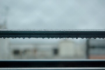 雨上がりの金属製の物干し竿についた滴る雨粒