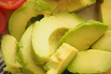 Fresh avocado slices arranged on a colorful plate