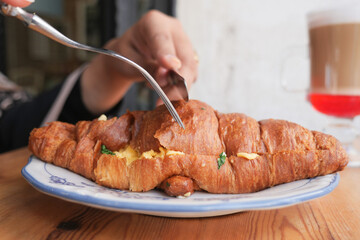 Enjoying a delicious croissant with coffee in a cozy cafe