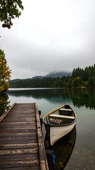 Obraz premium Lakeside scene with calm water and wooden dock