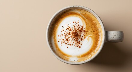 A perfectly frothed cappuccino topped with a delicate dusting of cinnamon, presented in a classic ceramic mug on a neutral background
